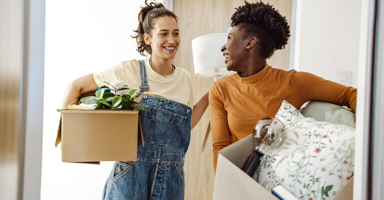 Two roommates moving into a college dormitory.