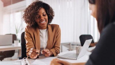 A businesswoman smiling and going over documents.