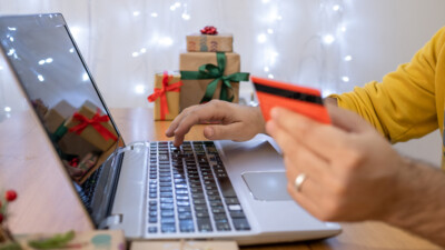 A person using a credit card to make an online purchase.