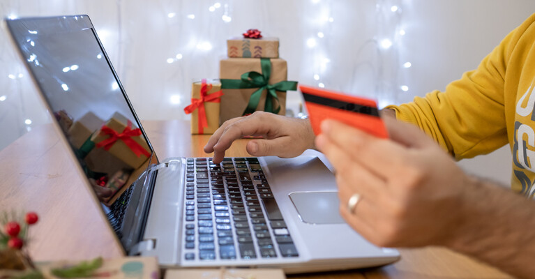 A person using a credit card to make an online purchase.