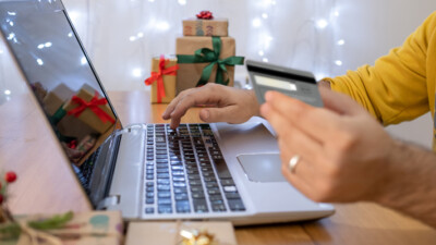 A person using a credit card to make an online purchase.