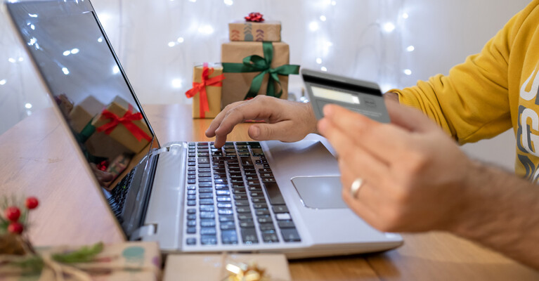 A person using a credit card to make an online purchase.