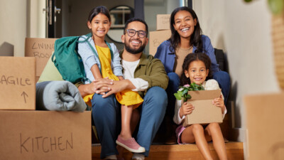 A family surrounded by moving boxes.