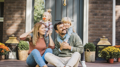 A family sitting on their front porch.