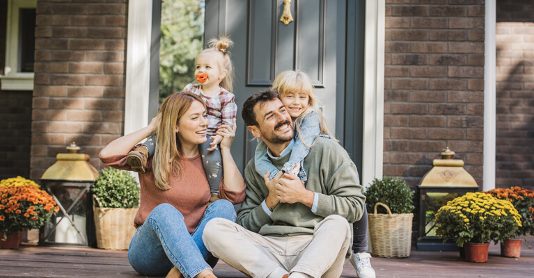 A family sitting on their front porch.