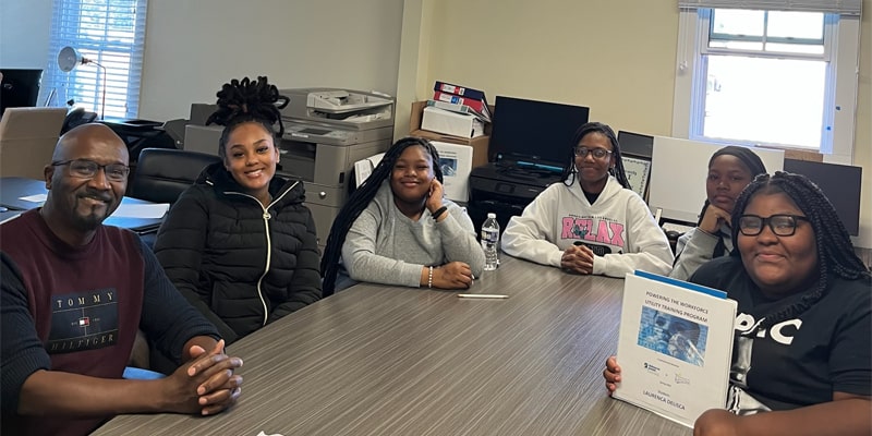 Group of youths from Pathways to Success sitting at a table.