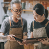 A small business owner talking with an employee.