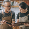 Two workers looking at tablets.