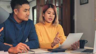 A man and a woman looking at documents.