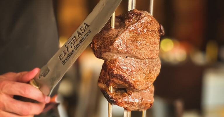 Piece of steak hanging at a Brazilian Steakhouse.